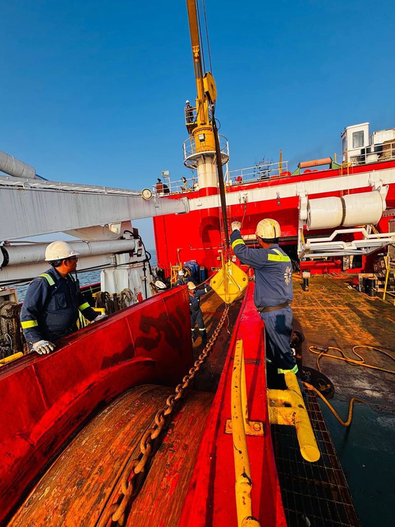 Crew Handling Cable on Deck